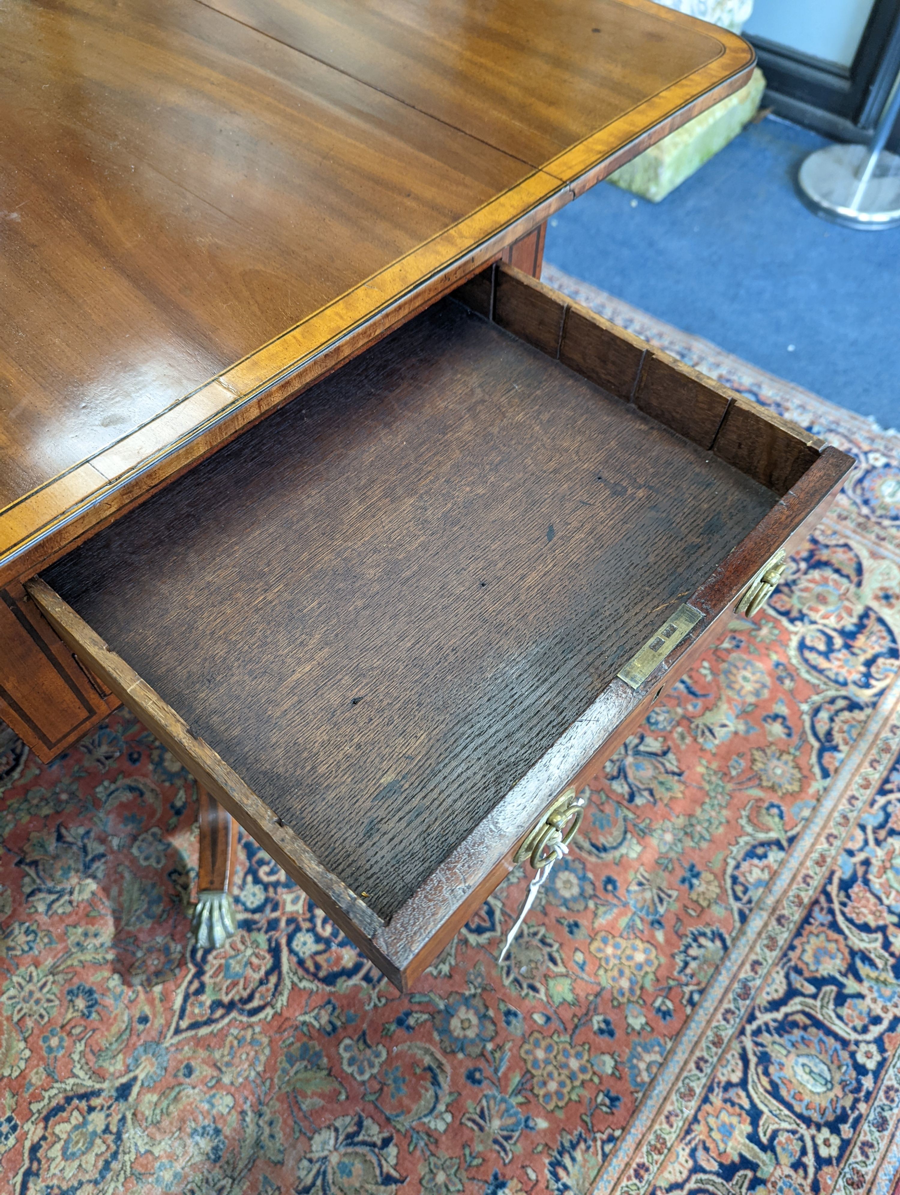 A Regency satinwood banded mahogany drop flap centre table, width 98cm extended, depth 56cm, height 73cm